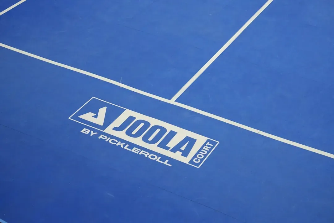 Different pickleball court surface materials including concrete, acrylic, and cushioned modular tiles showing texture and con