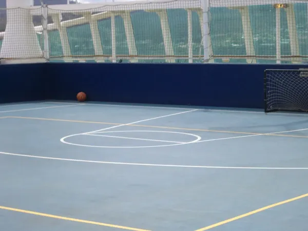 Pickleball ball machine launching balls on outdoor court during training practice session